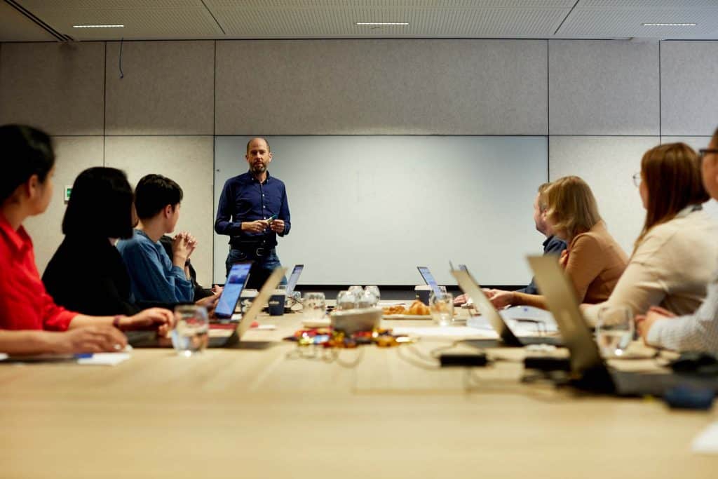 Man delivering customised SharePoint user training to a group of employees
