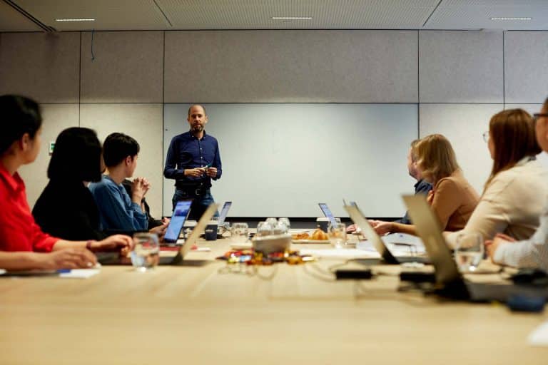 Man delivering customised SharePoint user training to a group of employees