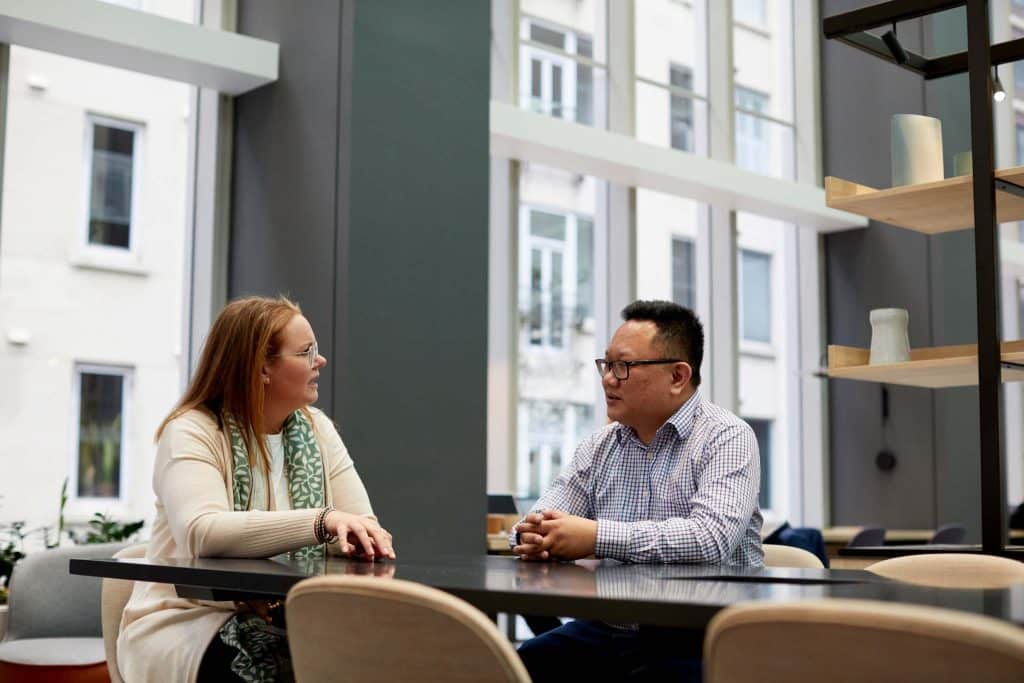 A man and woman discussing data storage best practices for O365