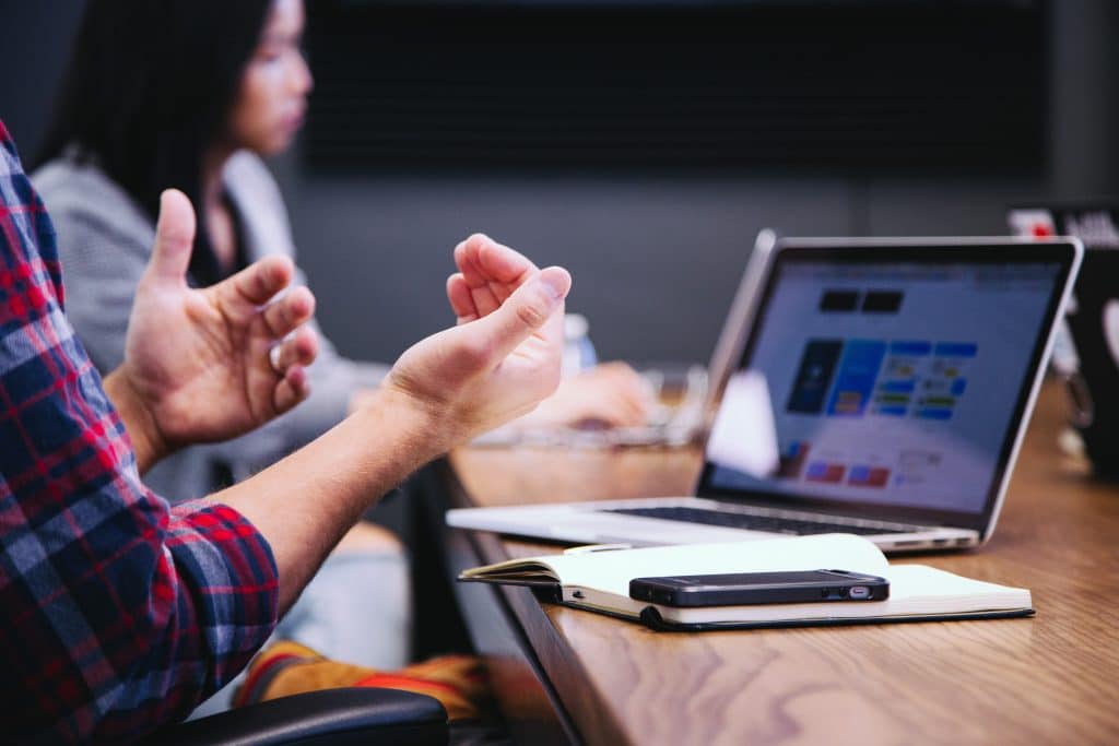 IT professionals working at laptop to address problems with SharePoint Online set up