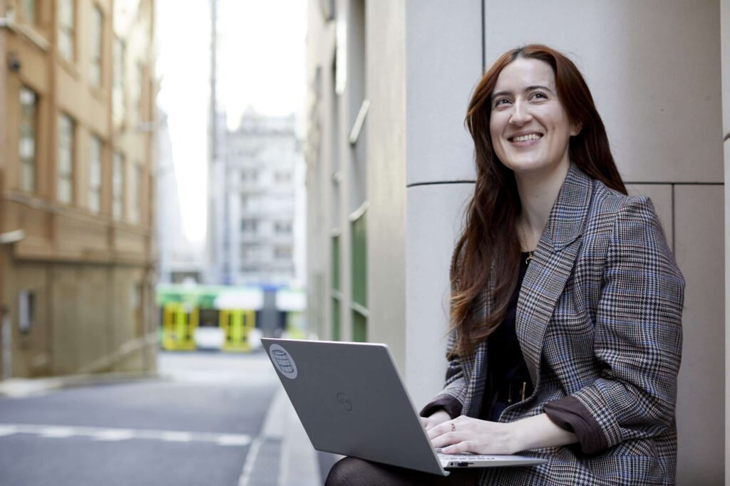 Worker using laptop in digital workplace
