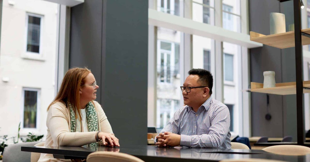 A man and woman discussing data storage best practices for O365