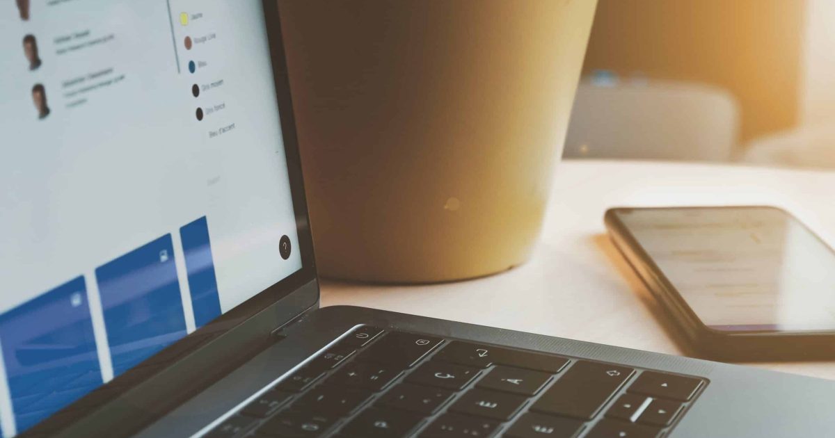 An open laptop, a smartphone sitting off to the left. Designing intranet security across all tech you use.