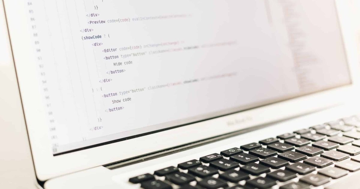 A close up on a laptop screen, showing HTML coding script.