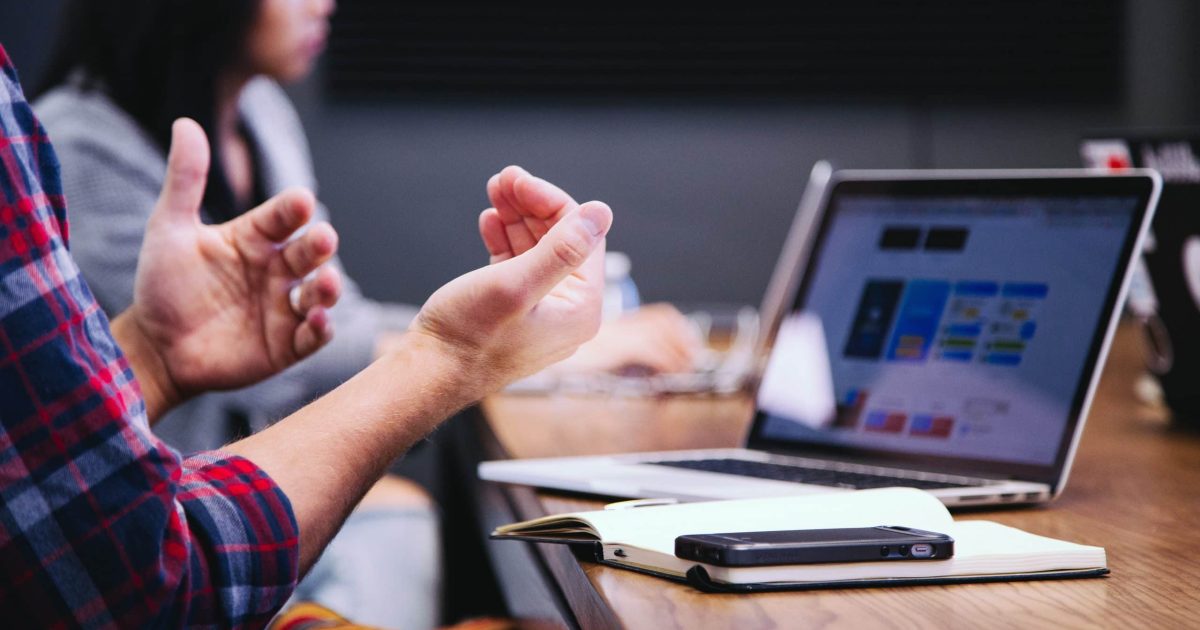 IT professionals working at laptop to address problems with SharePoint Online set up